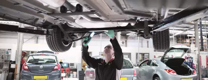 technician under car