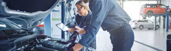 Technicians Working On Vehicle