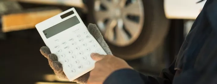Technician holding a calculator