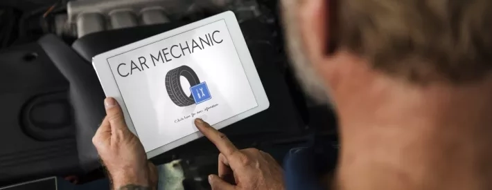 Mechanic holds tablet
