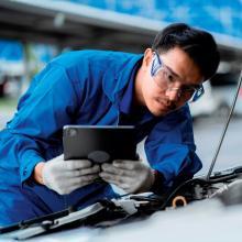 Technician inspects vehicle